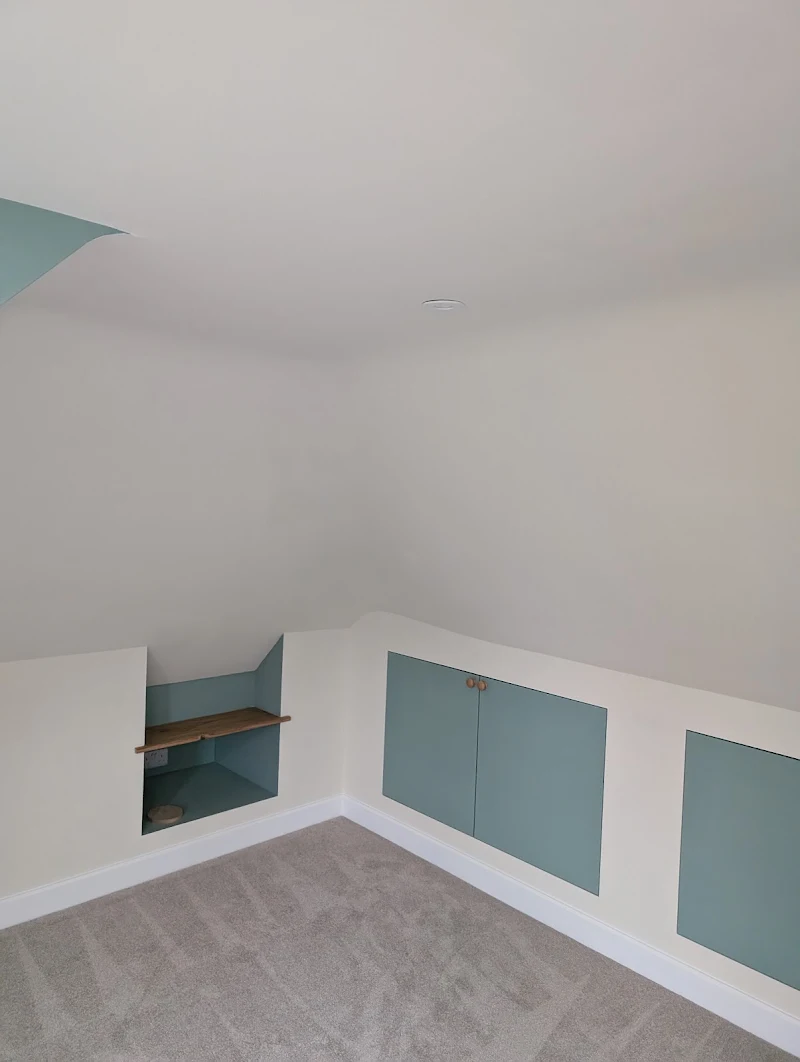 Painted storage nook finished in a muted sage-green tone