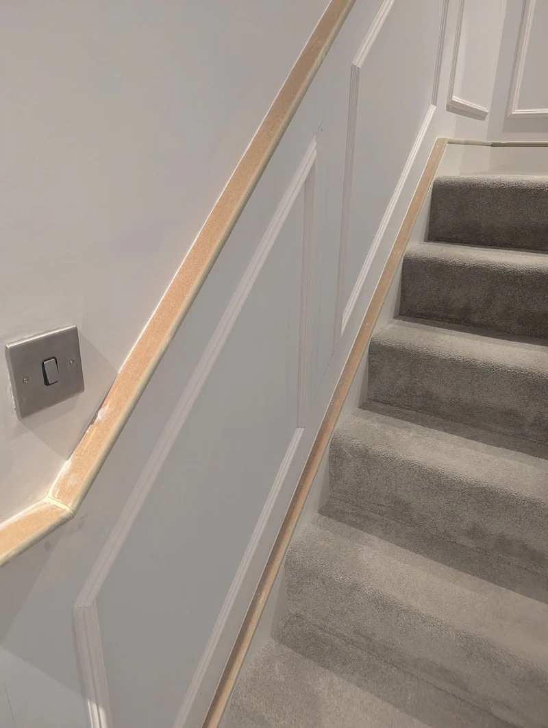 Close-up of freshly painted wall panelling and skirting detail